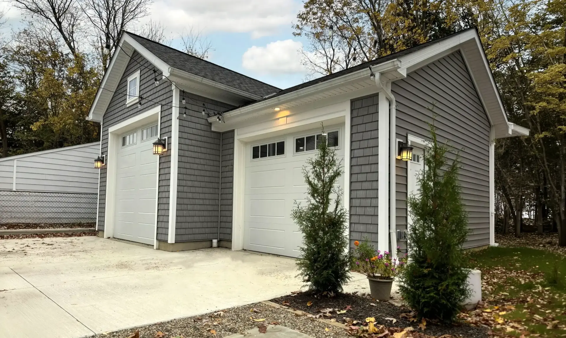 Completed two-car garage exterior with gray shingle siding